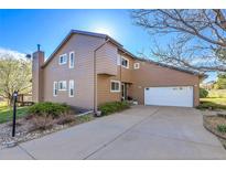 Charming two-story home with a large driveway and attached two-car garage at 6360 S Gibraltar Cir, Centennial, CO 80016