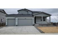 Charming two-story home featuring a three-car garage and a welcoming front porch area at 14366 Heritage Dr, Mead, CO 80504