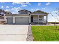 Charming home features a two-car garage, covered porch, and manicured lawn with beautiful landscaping at 14366 Heritage Dr, Mead, CO 80504