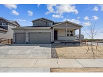 Attractive two-story home featuring a three car garage and covered front porch at 14366 Heritage Dr, Mead, CO 80504