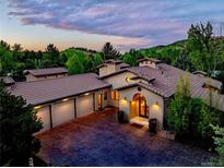 Stunning home featuring a terracotta-colored roof, attached garage, and well-manicured front yard, perfect for luxurious living at 5904 Meadowbrook Dr, Morrison, CO 80465