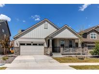 Charming single-Gathering home showcasing a well-manicured lawn and inviting covered front porch at 24197 E Ada Ave, Aurora, CO 80018