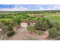 Expansive front yard and beautiful home with a two-car garage and ample parking in a scenic neighborhood at 3850 Hopi Dr, Sedalia, CO 80135