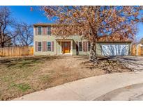 Charming two-story home with a well-maintained lawn and a two car garage at 14703 E Caspian Pl, Aurora, CO 80014