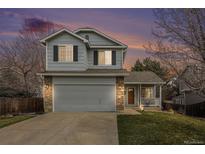 Charming two-story home featuring a two-car garage, inviting porch, and well-maintained lawn at 23813 Broadmoor Dr, Parker, CO 80138
