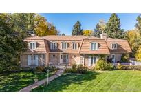 Beautiful two-story home with copper roof and landscaped lawn at 2209 Green Oaks Ln, Greenwood Village, CO 80121