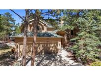 Two-story home featuring a three-car garage with lovely mature trees surrounding the property at 20050 Lost Arrowhead Dr, Monument, CO 80132