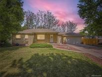 Charming brick home with a well-manicured lawn and inviting front entrance at 50 Yarrow St, Lakewood, CO 80226