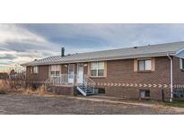 Quaint brick home featuring dual front entryways and a well-maintained roof at 15800-15802 E 11Th Ave, Aurora, CO 80011