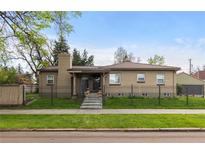 Charming brick home with a well-manicured lawn and wrought iron fence, perfect for curb appeal at 1090 E 3Rd Ave, Denver, CO 80218