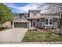Charming two-story home with a well-maintained front yard, stone accents, and an attached two-car garage at 2749 Pemberly Ave, Highlands Ranch, CO 80126