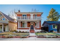 Charming two-story brick home with a spacious front porch and second story balcony at 2519 N Gilpin St, Denver, CO 80205