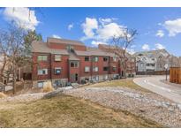 A view of the exterior of this townhouse showcasing its multi-story architecture and surrounding landscaping at 343 W Lehow Ave # 22, Englewood, CO 80110