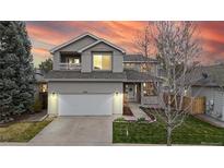 Charming two-story home boasts a well-manicured lawn and attached two-car garage, creating instant curb appeal at 5640 S Marshall St, Denver, CO 80123