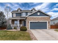 Charming two-story home with stone accents, dormers, and a covered front porch at 14669 Eagle River Run, Broomfield, CO 80023