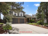Charming two-story home with a well-maintained front yard and a two-car garage at 7955 S Bemis St, Littleton, CO 80120