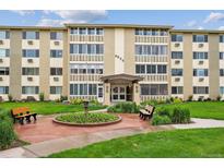 Welcoming exterior view of this condominium building with landscaped front entrance, benches, and well-maintained lawns at 9625 E Center Ave # 5D, Denver, CO 80247