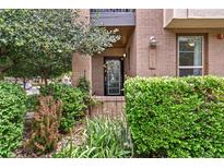Charming front entrance featuring brick facade, lush landscaping, and visible house number at 476 S Saulsbury St, Lakewood, CO 80226