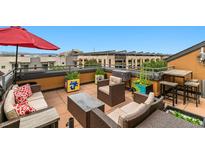 Enjoy outdoor living with this lovely rooftop patio featuring comfortable seating and colorful planter boxes at 476 S Saulsbury St, Lakewood, CO 80226