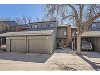Gray two-story home featuring an attached two-car garage and a brick chimney at 1513 48Th St # 7, Boulder, CO 80303