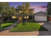 Charming two-story home with brick facade, well-maintained lawn, and inviting curb appeal at 7622 E Nassau Ave, Denver, CO 80237
