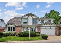 Charming two-story home with brick accents, manicured lawn, and a two-car garage at 8182 Sweet Water Rd, Lone Tree, CO 80124