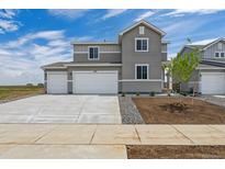 Inviting two-story home featuring a three-car garage and manicured front yard under a bright sky at 14412 Heritage Dr, Mead, CO 80504