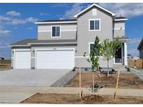Charming two-story home boasts a two-car garage, neutral siding, and a well-manicured front yard, perfect for suburban living at 14412 Heritage Dr, Mead, CO 80504