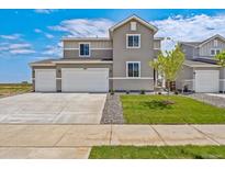 Inviting two-story home featuring a gray exterior, well-maintained lawn, and a spacious three-car garage at 14412 Heritage Dr, Mead, CO 80504