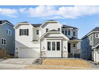 Charming two-story white home with a stone-accented facade, and an attached two-car garage at 16537 Black Rose Cir, Parker, CO 80134