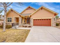 Charming single-Gathering home features a stone accents, a spacious two car garage, and manicured lawn at 9784 S Iris Ct, Littleton, CO 80127