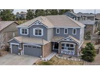 Beautiful two-story home featuring a well-maintained lawn, brick accents, and a welcoming front porch at 6746 S Biloxi Ct, Aurora, CO 80016