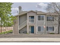 Charming condo with beautiful blue door, upper balcony, and neat landscaping at 3727 Cactus Creek Ct # 204, Highlands Ranch, CO 80126