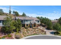 Elegant two-story home showcasing beautiful rock landscaping and a private driveway at 4788 Silver Pine Dr, Castle Rock, CO 80108