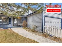 Charming two-story home with a front porch swing and a well-manicured lawn featuring $10,000 buyer incentive at 7729 Beverly Blvd, Castle Pines, CO 80108