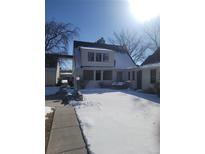 2-story house with snow covered yard, and a for sale sign at 230 S 22Nd Ave, Brighton, CO 80601