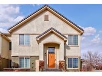 Inviting front entrance with an orange door and stone accents on a bright day at 22675 E Ontario Dr # 202, Aurora, CO 80016