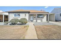 Charming home featuring a cozy covered porch, neat landscaping, and painted brick at 3340 Leyden St, Denver, CO 80207