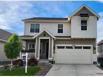 Two-story home with a two-car garage, a covered front porch, and a well-maintained landscaped yard at 27857 E 8Th Ave, Aurora, CO 80018