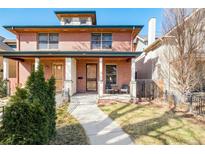 Charming brick duplex with a well-maintained front yard and covered porch at 449 N Pearl St, Denver, CO 80203