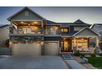 Charming two-story home featuring a spacious three-car garage and inviting front porch at 4965 Malaya St, Denver, CO 80249
