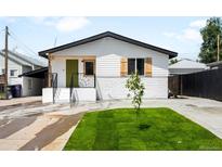Charming single-Gathering home featuring fresh exterior paint, a green front door, and a small tree in the front yard at 461 S Lowell Blvd, Denver, CO 80219