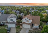Inviting two-story home with a well-maintained lawn, neutral color palette, and attached two-car garage at 3087 Deer Creek Trl, Highlands Ranch, CO 80129