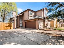 Charming two-story home features a basketball hoop, front-facing garage, and a well-maintained front yard at 6789 W Oregon Ave, Lakewood, CO 80232