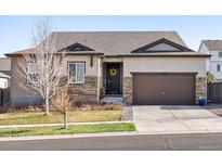 Charming single-Gathering home with a two-car garage, brown trim, stone accents, and a welcoming front door with a wreath at 17880 Weymouth Ave, Parker, CO 80134