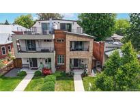 Contemporary home with stone and wood accents, showcasing balconies and landscaped front yard at 1426 S Pearl St, Denver, CO 80210