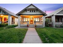 Charming home featuring a cozy front porch, well-manicured lawn, and inviting curb appeal at 1469 S Lincoln St, Denver, CO 80210
