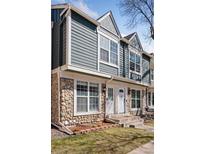 Charming townhome featuring a stone foundation, light blue siding, and crisp white trim and doors at 1260 S Idalia St, Aurora, CO 80017
