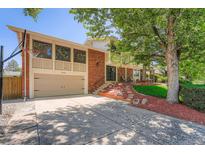 Charming brick home with well-manicured lawn, a driveway and basketball hoop for outdoor fun at 3752 S Helena Way, Aurora, CO 80013