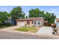 Charming single-Gathering home featuring a manicured front lawn and attached one car garage at 5167 Sable St, Denver, CO 80239